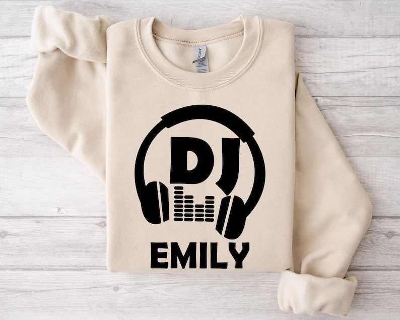 Perfect for DJs, music producers, festival performers and electronic music enthusiasts, this personalised DJ sweatshirt features a bold headphones graphic with your custom DJ name for a professional look. Ideal for gigs, studio sessions and everyday wear, every premium sweatshirt is professionally printed in the UK by TeezoraPrints using high-quality materials for warmth and comfort.