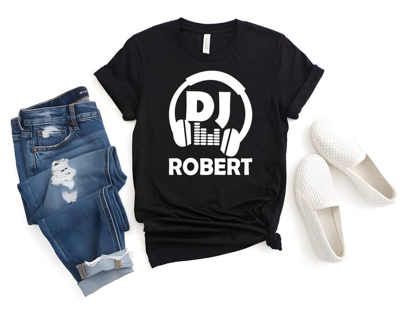 Custom DJ Name T Shirt designed as a thoughtful gift for DJs, music producers, festival lovers, club performers and electronic music fans. Perfect for birthdays, Christmas celebrations, special occasions and personalised gifting. This unique shirt combines music culture with personalisation to create a memorable keepsake.