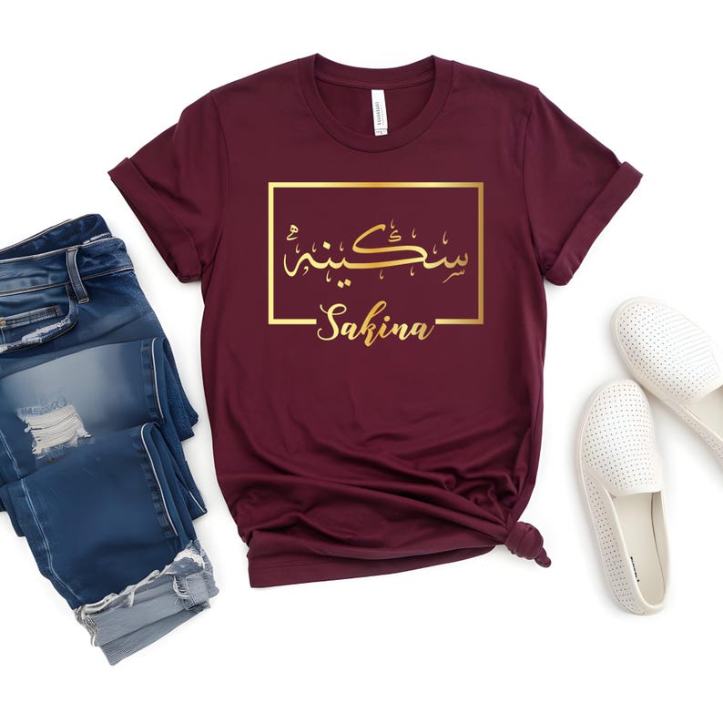 Personalised Arabic Name Shirt for women featuring elegant custom Arabic calligraphy and gold typography design. Unique Arabic text t shirt ideal for Muslim gifts, personalised Eid presents, Ramadan fashion, Arabic name clothing, custom Islamic apparel and personalised Arabic gifts. Perfect for buyers searching for meaningful custom clothing with a stylish and modern appearance that stands out from standard designs.