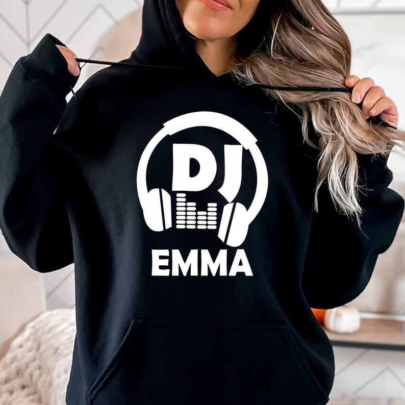 Perfect for DJs, music producers, festival performers and electronic music enthusiasts, this personalised DJ hoodie features a bold headphones graphic with your custom DJ name. Designed for comfort and style, it's ideal for performances, studio sessions and everyday wear. Every premium hoodie is professionally printed in the UK by TeezoraPrints using high-quality materials for warmth and durability.
