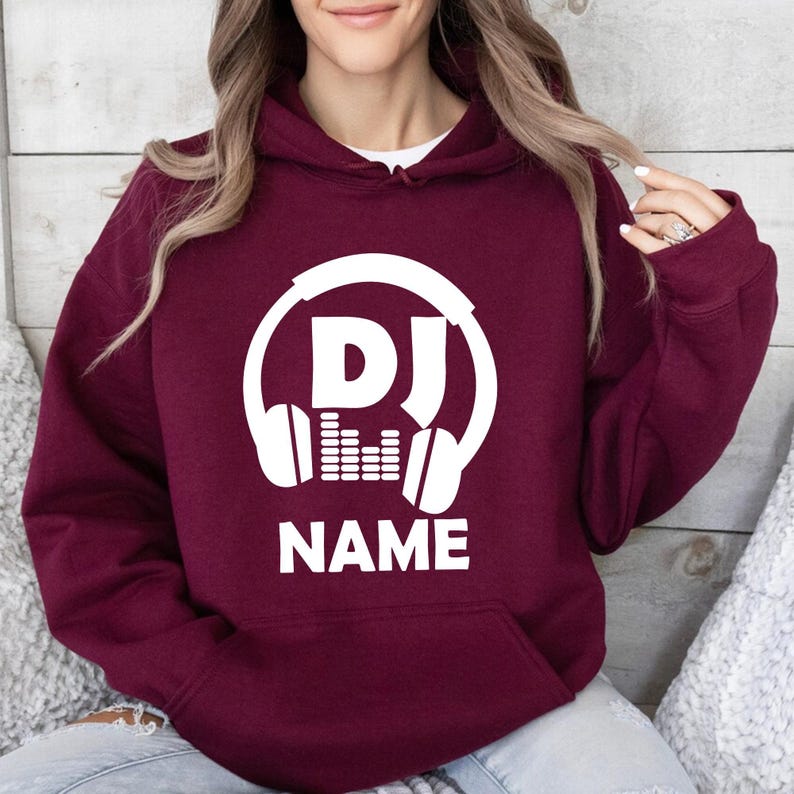 Personalised DJ hoodie, custom DJ name hoodie, DJ headphones hoodie, music producer hoodie, disc jockey apparel, EDM clothing, festival hoodie, stage performance hoodie, custom music gift and premium winter hoodie. Every premium hoodie is proudly printed in the UK by TeezoraPrints for everyday comfort and quality.
