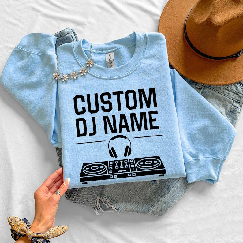 Create a unique personalised DJ sweatshirt by adding your own DJ name above the controller graphic. Perfect for professional DJs, beginners, producers and entertainers looking for custom apparel. Every sweatshirt is made to order and professionally printed in the UK by TeezoraPrints.