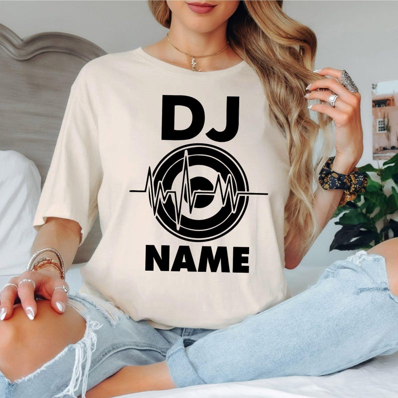 Searching for the perfect gift for a DJ? This personalised DJ shirt is a thoughtful gift for birthdays, Christmas, Father's Day, Mother's Day or special celebrations. Featuring your custom DJ name with a heartbeat turntable design, every premium shirt is professionally printed in the UK by TeezoraPrints for a memorable personalised gift.