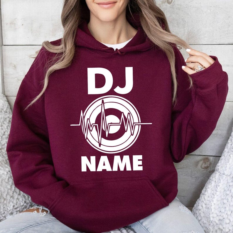 Looking for the perfect gift for a DJ or music producer? This personalised DJ hoodie makes a thoughtful gift for birthdays, Christmas, Father's Day, Mother's Day and special occasions. Featuring a custom DJ name with heartbeat artwork, every hoodie is professionally printed in the UK by TeezoraPrints.
