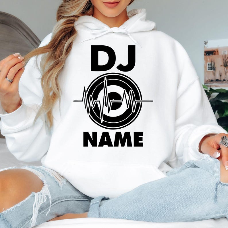 Personalised DJ hoodie, custom DJ name hoodie, heartbeat DJ pullover, music producer hoodie, disc jockey apparel, electronic music clothing, festival outfit, stage performance hoodie, custom music gift and premium winter wear. Every hoodie is proudly printed in the UK by TeezoraPrints.