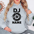 Celebrate your passion for DJ culture with this personalised hoodie showcasing a custom name and stylish heartbeat turntable artwork. Ideal for club performances, festivals, studio work and casual wear. Every premium hoodie is professionally printed in the UK by TeezoraPrints.
