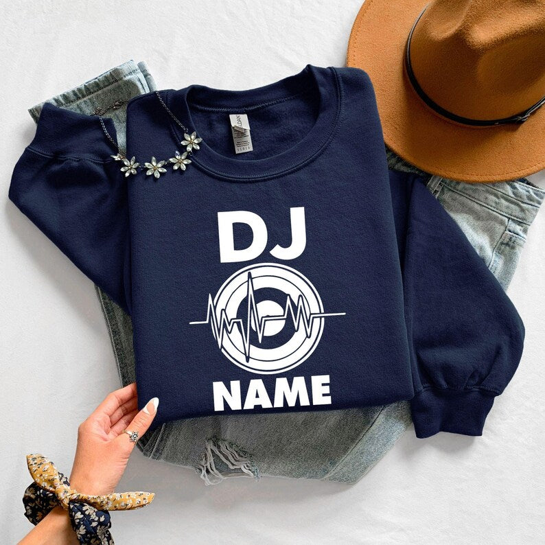 Personalised DJ sweatshirt, custom DJ name jumper, heartbeat crewneck, music producer apparel, disc jockey clothing, electronic music fashion, festival outfit, stage performance sweatshirt, custom music gift and premium winter wear. Every order is proudly printed in the UK by TeezoraPrints for quality and comfort.