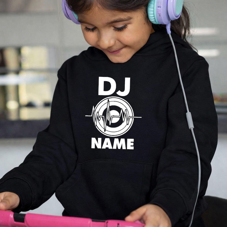 Designed for DJs, music producers, festival performers and electronic music lovers, this personalised DJ hoodie features a custom DJ name with a heartbeat turntable graphic. Ideal for performances, studio sessions and casual outfits, every premium hoodie is professionally printed in the UK by TeezoraPrints using high-quality fabric for warmth and lasting comfort.