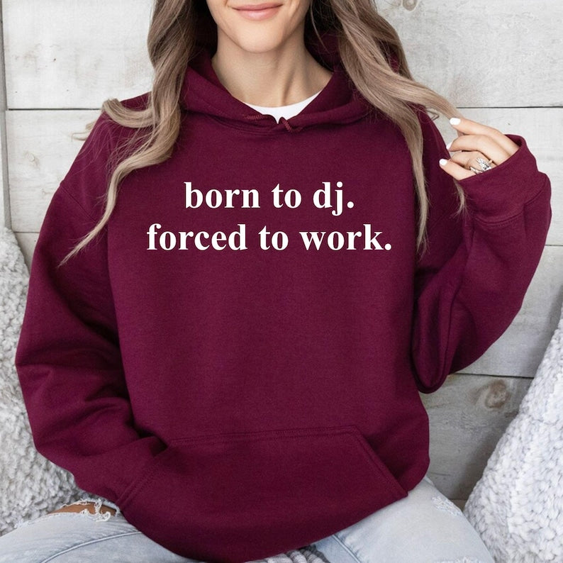 Show everyone where your passion really belongs with this Born To DJ. Forced To Work. Hoodie. Designed with a clean statement quote and crafted from soft premium fabric, it's ideal for DJs, producers and electronic music fans who love stylish, comfortable apparel. Perfect for club nights, festivals, travelling or relaxing between performances. Every hoodie is professionally printed in the UK by TeezoraPrints.