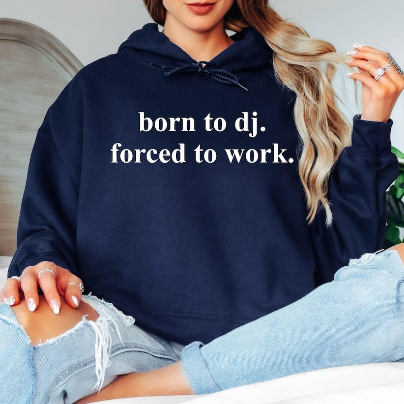 Funny DJ hoodie, Born To DJ Forced To Work hoodie, DJ quote hoodie, music producer hoodie, disc jockey apparel, EDM hoodie, electronic music clothing, festival hoodie, rave fashion, nightclub outfit, graphic hoodie, novelty music gift and premium unisex hoodie. Every premium garment is professionally printed in the UK by TeezoraPrints for comfort, durability and everyday style.