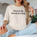 Express your passion for DJ culture with this Born To DJ Forced To Work graphic t-shirt. Whether you're mixing tracks in the studio, performing live, travelling to festivals, relaxing with friends or creating new playlists at home, this premium unisex tee delivers all-day comfort and effortless style. Every shirt is proudly printed in the UK by TeezoraPrints, making it an excellent addition to any music lover's wardrobe.