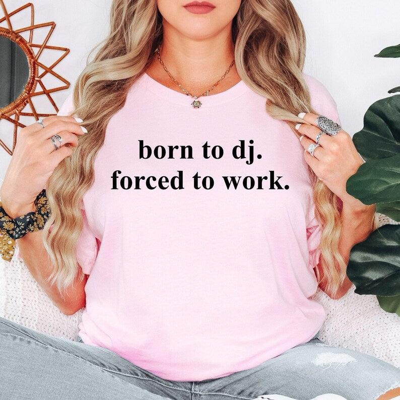 Perfect for DJ gigs, nightclub events, music festivals, rehearsal sessions, recording studios, bachelor parties, concerts, weekend outings, holidays and casual everyday wear. This humorous Born To DJ Forced To Work t-shirt combines premium comfort with a fun music-inspired design that stands out wherever you go. Every order is professionally printed in the UK by TeezoraPrints using durable, high-quality printing methods.