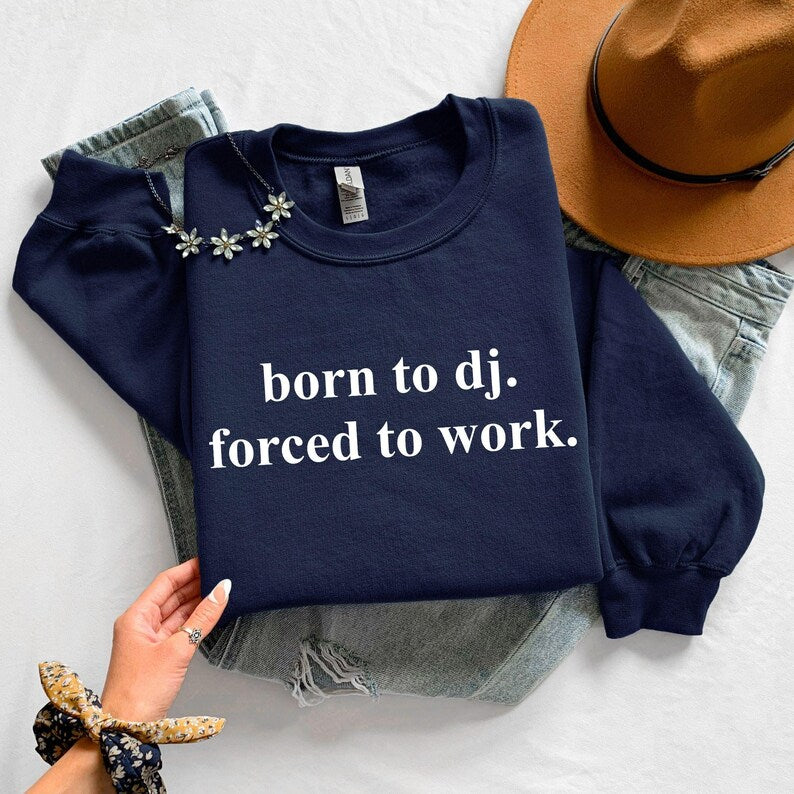 Funny DJ sweatshirt, Born To DJ Forced To Work jumper, DJ quote crewneck, music producer sweatshirt, disc jockey apparel, EDM clothing, electronic music fashion, club DJ outfit, festival sweatshirt, rave clothing, novelty music gift and premium statement apparel. Every premium sweatshirt is proudly printed in the UK by TeezoraPrints for everyday comfort and lasting quality.