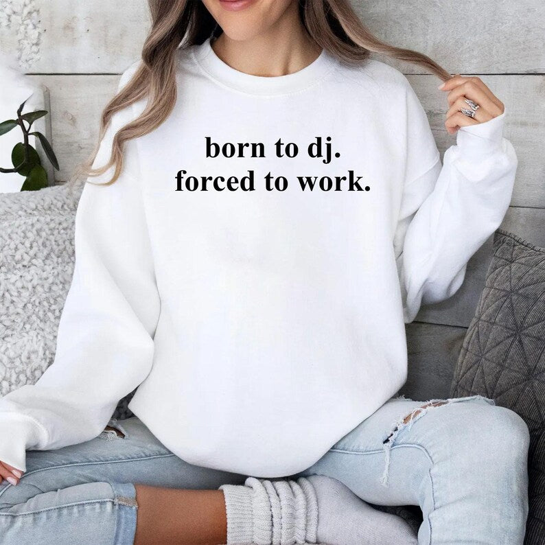 Designed for DJs, music producers, club performers and electronic music enthusiasts, this Born To DJ. Forced To Work. sweatshirt is perfect for anyone whose true passion is making music. Featuring a bold typography design with a humorous message, it's ideal for studio sessions, club nights, festivals and everyday wear. Every premium crewneck is professionally printed in the UK by TeezoraPrints using high-quality materials for exceptional comfort and durability.