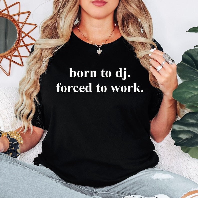 Designed for DJs, music producers, club performers, EDM fans and electronic music lovers, this graphic t-shirt features the bold slogan "Born To DJ. Forced To Work." Perfect for anyone who would rather be behind the decks than stuck at a day job. Whether you're performing live, producing tracks, entertaining at private events or showing your passion for music, this premium shirt delivers comfort, style and personality. Every order is professionally printed in the UK by TeezoraPrints using premium-quality 