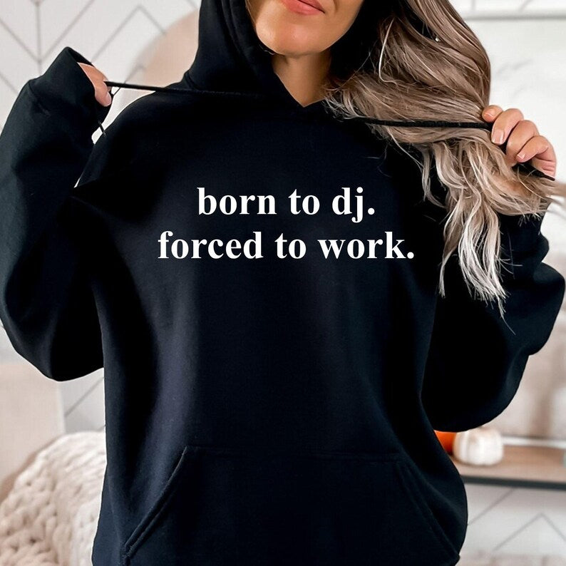Created for DJs, music producers, club performers and electronic music enthusiasts, this Born To DJ. Forced To Work. Hoodie combines humour with everyday comfort. Featuring a clean minimalist quote, this premium hoodie is perfect for anyone whose true passion is music. Ideal for festivals, studio sessions, live performances and casual wear, every hoodie is professionally printed in the UK by TeezoraPrints using premium-quality fabric for long-lasting comfort.