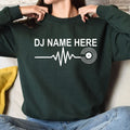 Featuring a custom DJ name, heartbeat waveform and vinyl record graphic, this personalised sweatshirt creates a clean modern look for DJs and music lovers. Professionally printed in the UK by TeezoraPrints using premium-quality materials.