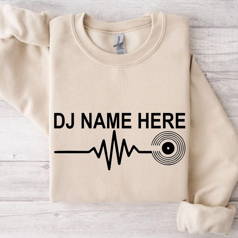 Perfect for DJ performances, club nights, music festivals, recording studios, concerts, parties and everyday casual wear. This personalised DJ Name Heartbeat Sweatshirt combines custom style with premium comfort. Printed in the UK by TeezoraPrints.