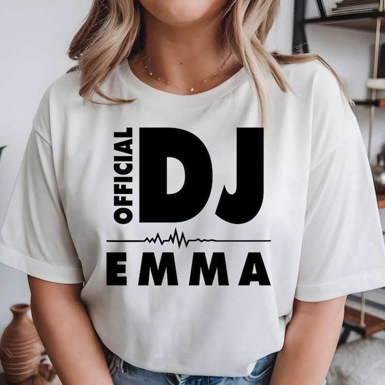 Personalised Official DJ T-Shirt featuring a custom name and bold heartbeat graphic, created for DJs, music producers, club performers and electronic music lovers. This premium unisex tee is professionally printed in the UK by TeezoraPrints using high-quality materials for outstanding comfort, durability and everyday style. Perfect for performances, festivals, parties and casual wear while showcasing your unique DJ identity.