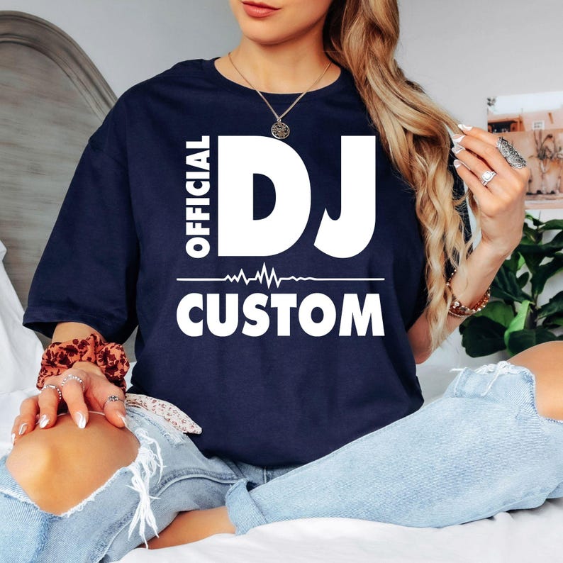 Official DJ shirt, custom DJ name t-shirt, personalised DJ tee, disc jockey shirt, music producer t-shirt, DJ gift, EDM clothing, heartbeat DJ design, festival shirt, club DJ apparel, music lover shirt, custom printed t-shirt and premium unisex graphic tee printed in the UK by TeezoraPrints.