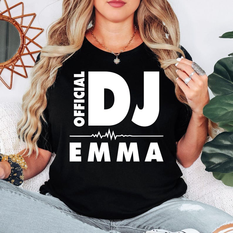 Personalised Official DJ T-Shirt featuring a custom name and bold heartbeat graphic, created for DJs, music producers, club performers and electronic music lovers. This premium unisex tee is professionally printed in the UK by TeezoraPrints using high-quality materials for outstanding comfort, durability and everyday style. Perfect for performances, festivals, parties and casual wear while showcasing your unique DJ identity.