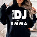 Personalised Official DJ Heartbeat Hoodie featuring a custom name, bold Official DJ typography and a heartbeat waveform graphic. Designed for professional DJs, music producers, club performers and electronic music lovers who want to represent their passion with a premium personalised hoodie. Professionally printed in the UK by TeezoraPrints using high-quality materials for warmth, comfort and long-lasting durability.