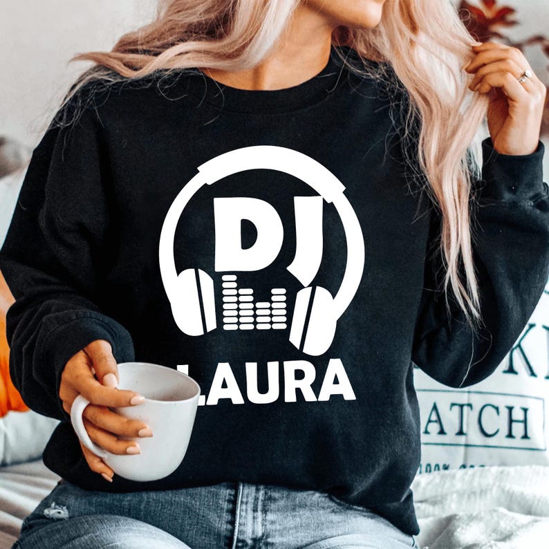 Perfect for DJs, music producers, festival performers and electronic music enthusiasts, this personalised DJ sweatshirt features a bold headphones graphic with your custom DJ name for a professional look. Ideal for gigs, studio sessions and everyday wear, every premium sweatshirt is professionally printed in the UK by TeezoraPrints using high-quality materials for warmth and comfort.