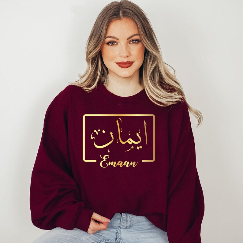 Custom Arabic Text Sweatshirt designed for modern everyday fashion and comfortable casual wear. Perfect for family gatherings, travel, university life, shopping trips, casual outings, Eid celebrations, and relaxed weekends. This personalised sweatshirt combines premium comfort, elegant Arabic typography, and contemporary styling for a fashionable and meaningful look.