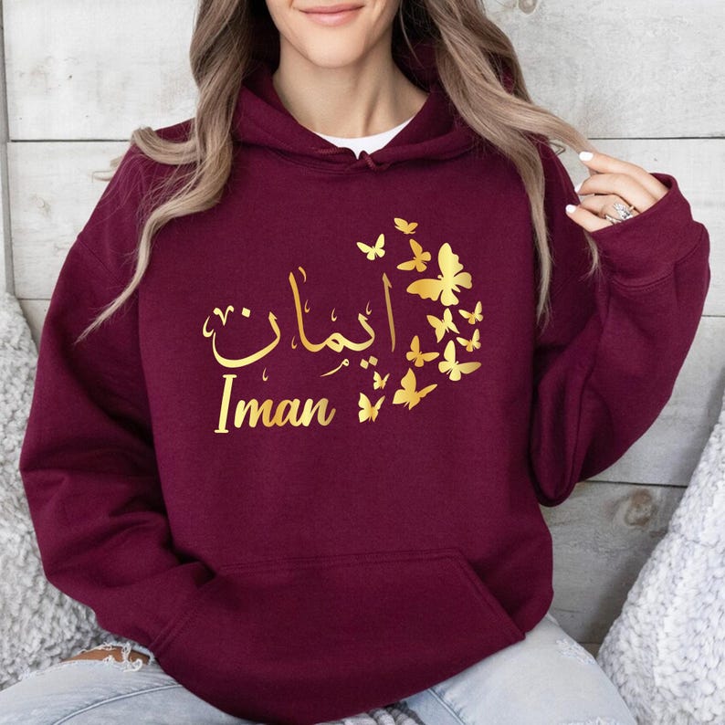 Personalised Arabic Name Hoodie, custom Arabic calligraphy hoodie, butterfly Arabic hoodie, Arabic typography hoodie, personalised Arabic clothing, Islamic fashion hoodie, Muslim women hoodie, Arabic script apparel, butterfly graphic hoodie, custom name hoodie, personalised Muslim gift, premium Arabic fashion, personalised Islamic clothing, and custom Arabic text fashion with elegant personalised styling.