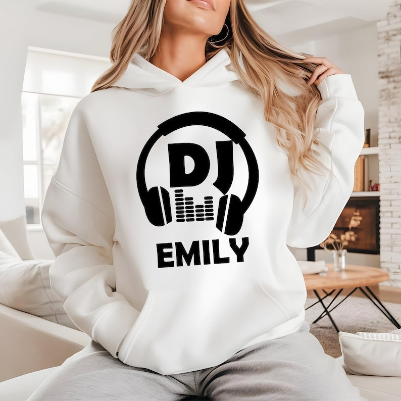 Perfect for DJs, music producers, festival performers and electronic music enthusiasts, this personalised DJ hoodie features a bold headphones graphic with your custom DJ name. Designed for comfort and style, it's ideal for performances, studio sessions and everyday wear. Every premium hoodie is professionally printed in the UK by TeezoraPrints using high-quality materials for warmth and durability.