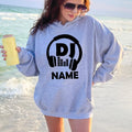 Express your passion for music with this personalised DJ hoodie featuring a custom name and bold headphones design. Whether performing live, creating new mixes, travelling to events or relaxing at home, this premium hoodie offers warmth, comfort and standout style. Every hoodie is proudly printed in the UK by TeezoraPrints.