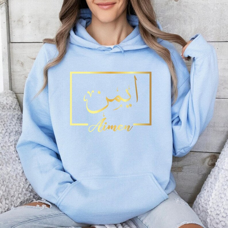 Stylish personalised Arabic name hoodie designed for everyday wear, casual outings, family gatherings, coffee dates, travel, university, shopping trips, and relaxed weekends. The premium black hoodie paired with elegant gold Arabic calligraphy creates a fashionable look that blends modern style with cultural inspiration. Comfortable, versatile, and meaningful, it complements a wide range of outfits while allowing the wearer to express their identity through personalised fashion.