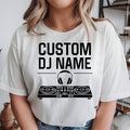 Personalised DJ shirt featuring a custom DJ name, headphones and DJ controller graphic for disc jockeys, music producers and EDM artists. Ideal for nightclub performances, music festivals, recording studios and live events. Every premium graphic t-shirt is professionally printed in the UK by TeezoraPrints with vibrant print quality and lasting durability.