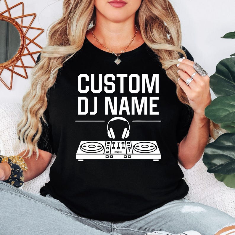Perfect for DJs, music producers, festival performers and electronic music enthusiasts, this personalised Custom DJ Name shirt features a professional DJ controller and headphones graphic with your custom stage name. Designed for performances, studio sessions and everyday wear, every premium t-shirt is professionally printed in the UK by TeezoraPrints using high-quality materials for exceptional comfort.