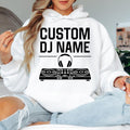 Personalised DJ hoodie featuring a custom DJ name with controller and headphones artwork for music producers, club performers and EDM artists. Ideal for festivals, recording studios, nightclub events and casual wear. Every premium hoodie is professionally printed in the UK by TeezoraPrints with vibrant, durable print quality.