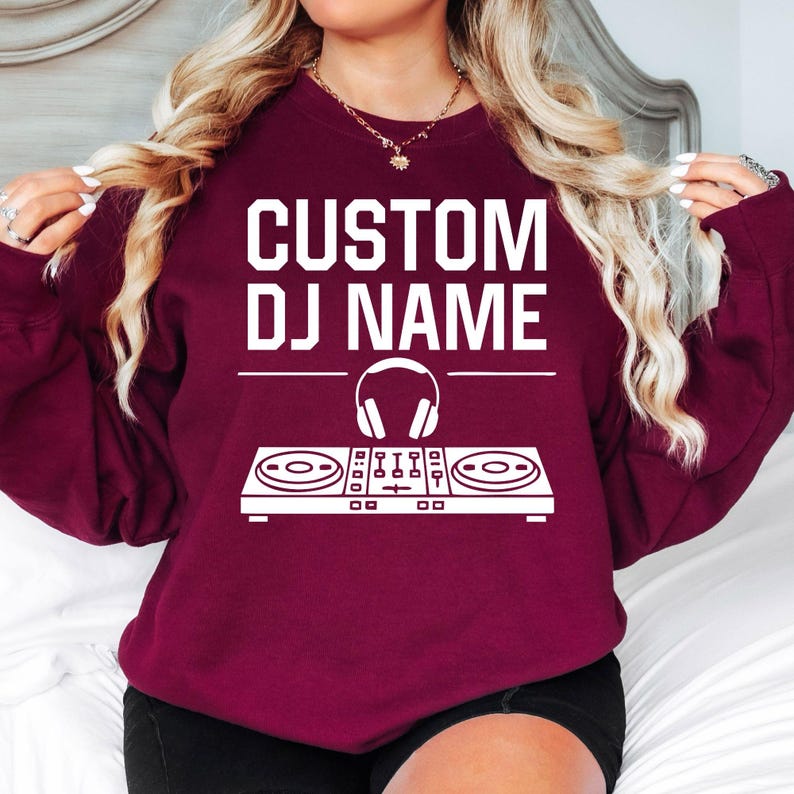 Stand out with this personalised DJ sweatshirt featuring your custom DJ name and modern controller artwork. Soft premium fabric, relaxed unisex fit and professional printing make it perfect for performances, festivals and daily wear. Every sweatshirt is made to order and professionally printed in the UK by TeezoraPrints.