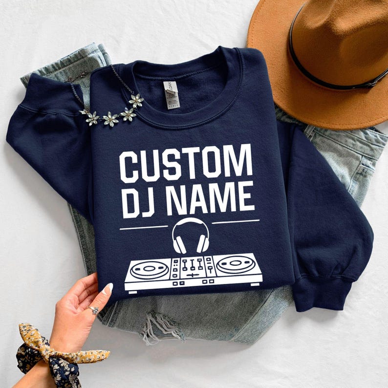 Personalised DJ sweatshirt, custom DJ name crewneck, DJ controller sweatshirt, music producer jumper, disc jockey apparel, electronic music clothing, festival outfit, studio sweatshirt, performance wear and premium personalised fashion. Every order is proudly printed in the UK by TeezoraPrints.