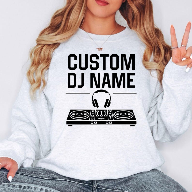 Custom DJ sweatshirt designed for DJs, producers, EDM artists, club entertainers and festival performers. Perfect for live shows, rehearsals, recording sessions, concerts and everyday outfits. Every premium crewneck is professionally printed in the UK by TeezoraPrints for lasting comfort and exceptional quality.