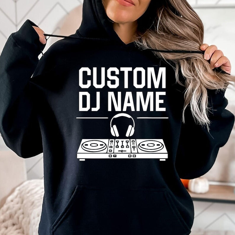Designed for DJs, producers, festival performers and electronic music lovers, this personalised hoodie features a custom DJ name with a professional controller and headphones graphic. Perfect for performances, studio sessions and everyday outfits, every premium hoodie is professionally printed in the UK by TeezoraPrints using high-quality fabric for lasting comfort.