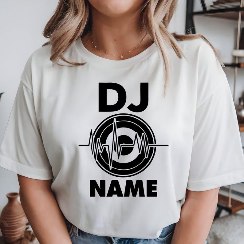 Perfect for DJs, music producers, festival performers and electronic music lovers, this personalised DJ shirt features a custom DJ name with a modern heartbeat turntable graphic. Designed for gigs, studio sessions and casual everyday wear, every premium t-shirt is professionally printed in the UK by TeezoraPrints using high-quality materials for exceptional comfort and durability.