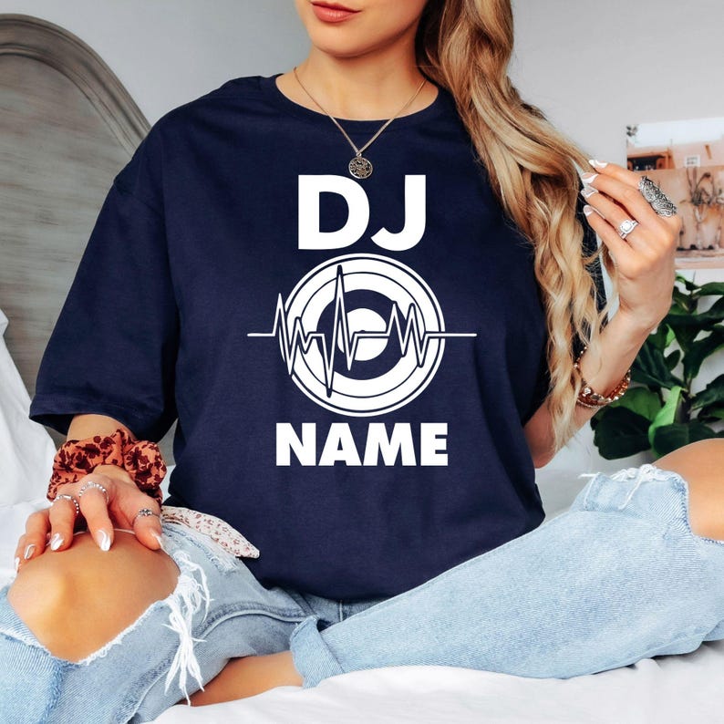 Personalised DJ shirt, custom DJ name t shirt, DJ heartbeat tee, music producer shirt, disc jockey apparel, festival DJ clothing, electronic music shirt, custom music gift, stage performance tee and premium casual t-shirt. Every premium shirt is proudly printed in the UK by TeezoraPrints for comfort and professional quality.