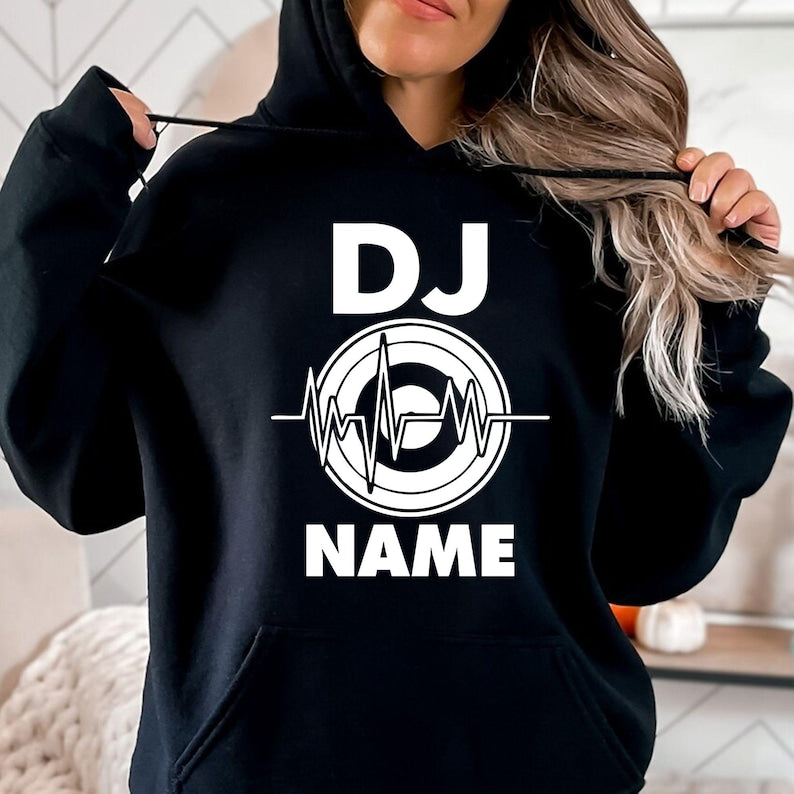 Designed for DJs, music producers, festival performers and electronic music lovers, this personalised DJ hoodie features a custom DJ name with a heartbeat turntable graphic. Ideal for performances, studio sessions and casual outfits, every premium hoodie is professionally printed in the UK by TeezoraPrints using high-quality fabric for warmth and lasting comfort.