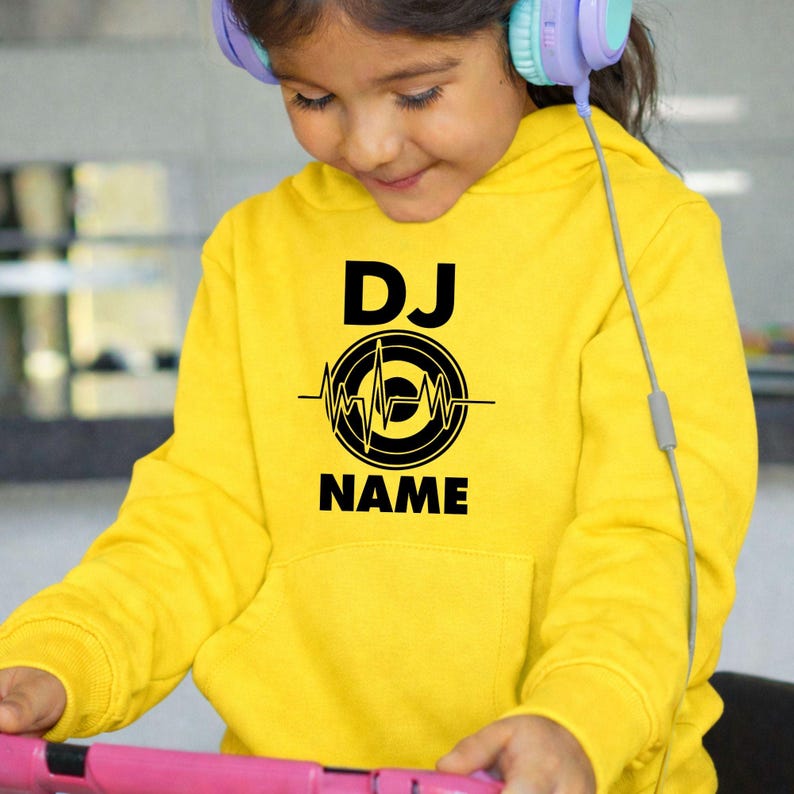 Express your love for music with this personalised DJ hoodie featuring a custom name and heartbeat turntable design. Whether performing live, creating new mixes, attending festivals or relaxing with friends, this premium hoodie delivers comfort and standout style. Every hoodie is proudly printed in the UK by TeezoraPrints.