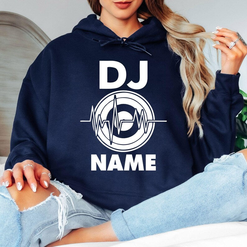 Stand out with this personalised DJ hoodie featuring your custom name and heartbeat turntable design. Soft premium fabric, relaxed unisex fit and professional printing make it perfect for performances, festivals and everyday wear. Every hoodie is made to order and professionally printed in the UK by TeezoraPrints.
