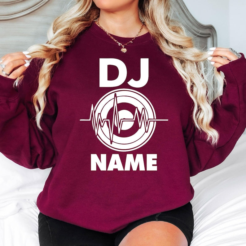 Perform in style with this personalised DJ sweatshirt featuring your custom name and modern heartbeat turntable design. Soft premium fabric, relaxed unisex fit and durable professional printing make it an excellent choice for music lovers. Every sweatshirt is made to order and professionally printed in the UK by TeezoraPrints.