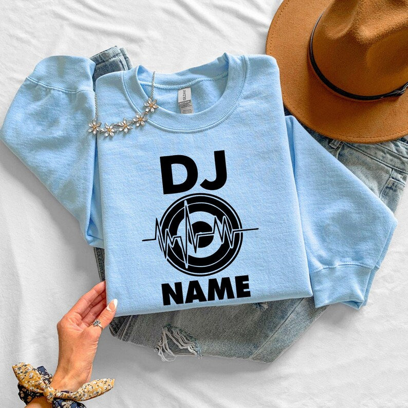 Create a one-of-a-kind personalised DJ sweatshirt by adding your own DJ name beneath the heartbeat turntable artwork. Perfect for professional DJs, beginners, producers and entertainers wanting custom apparel. Every sweatshirt is made to order and professionally printed in the UK by TeezoraPrints with exceptional attention to detail.