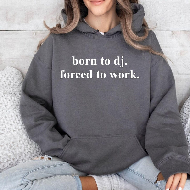 Express your passion for DJ culture with this Born To DJ. Forced To Work. Hoodie featuring a bold minimalist quote that perfectly captures every music lover's mindset. Whether you're performing live, creating new tracks, travelling to events or relaxing with friends, this premium hoodie delivers warmth, comfort and standout style. Printed in the UK by TeezoraPrints.