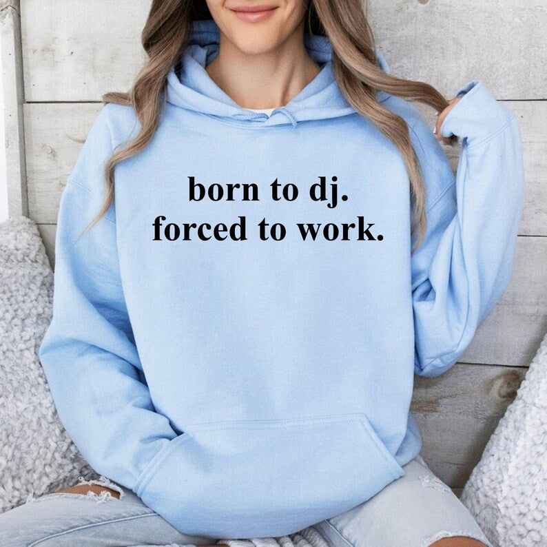 Celebrate your passion for music with this Born To DJ. Forced To Work. Hoodie, featuring a witty statement that perfectly describes life as a DJ. Designed for producers, club performers and EDM fans, this premium hoodie offers outstanding comfort while making people smile. Every hoodie is proudly printed in the UK by TeezoraPrints using premium-quality materials.