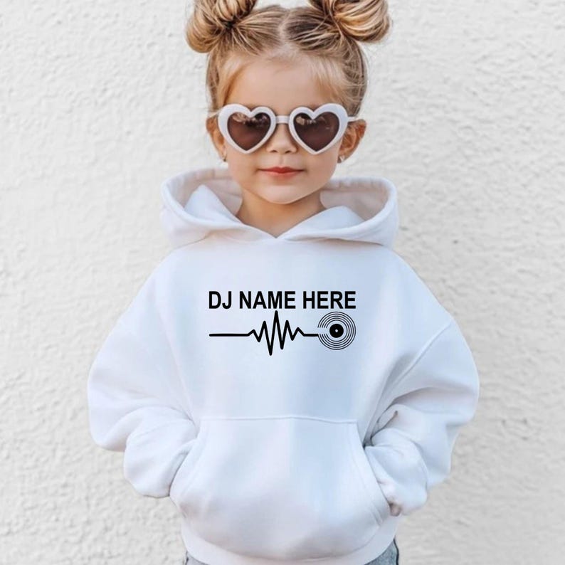 Perfect for DJ performances, club nights, music festivals, recording studios, concerts, parties and everyday casual wear. This personalised DJ Name Heartbeat Hoodie combines custom style with premium comfort. Printed in the UK by TeezoraPrints.