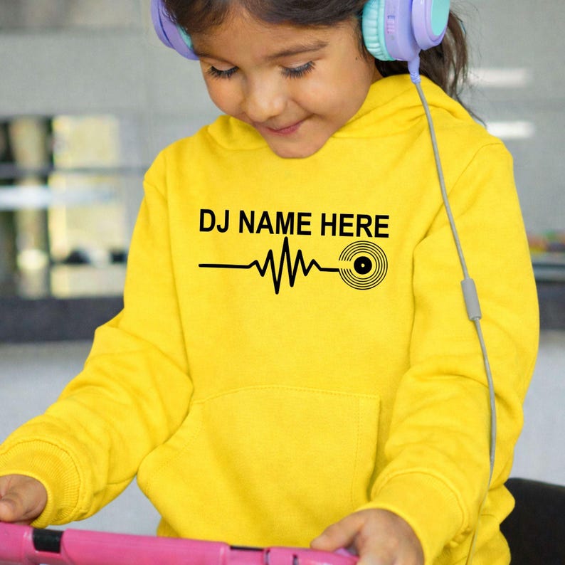 Express your passion for music with this personalised DJ Name Heartbeat Hoodie featuring a heartbeat waveform connected to a vinyl record. Whether performing behind the decks or relaxing with friends, this premium hoodie is professionally printed in the UK by TeezoraPrints.